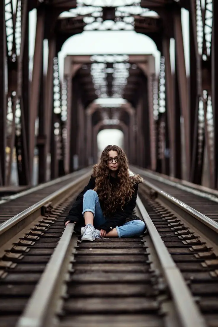 Download Girl Sitting on Railway Background