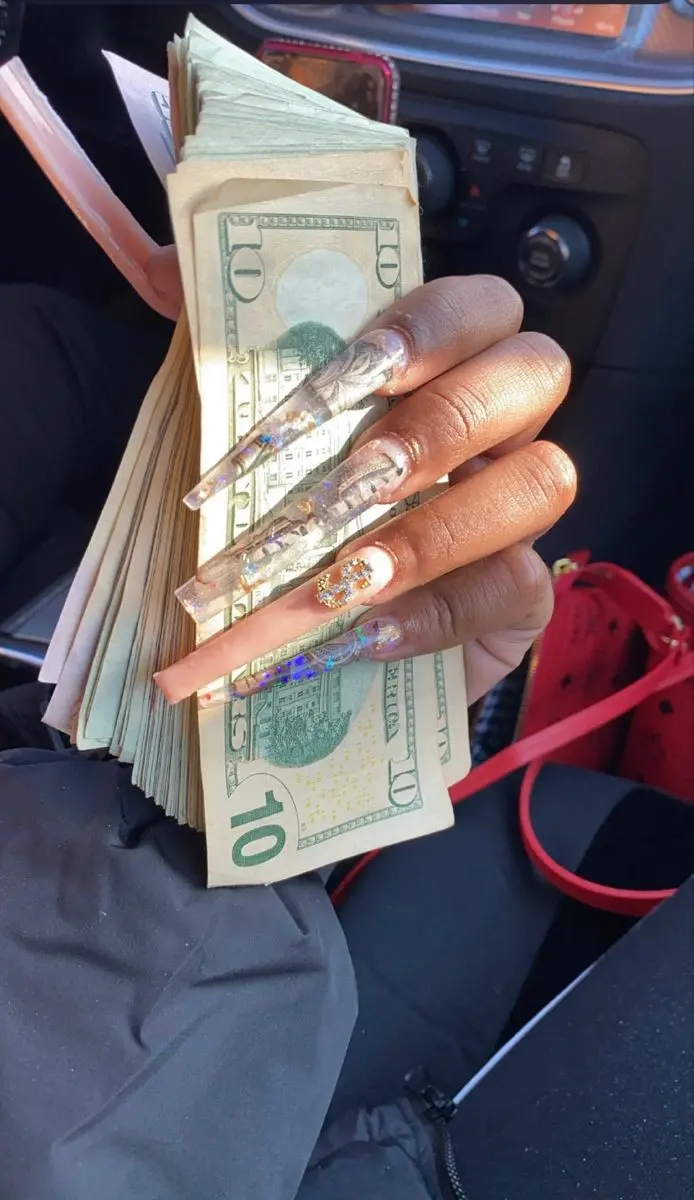 Download Background Image of US Dollars in a Girl's Hand