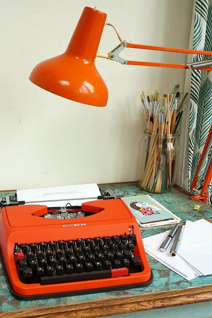 Download Orange Typewriter on Study Desk Background