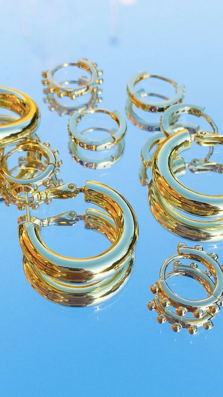 Download Wallpapers of Gold Earrings on Mirror