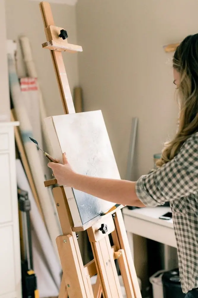 Girl Painter Next to Canvas Image