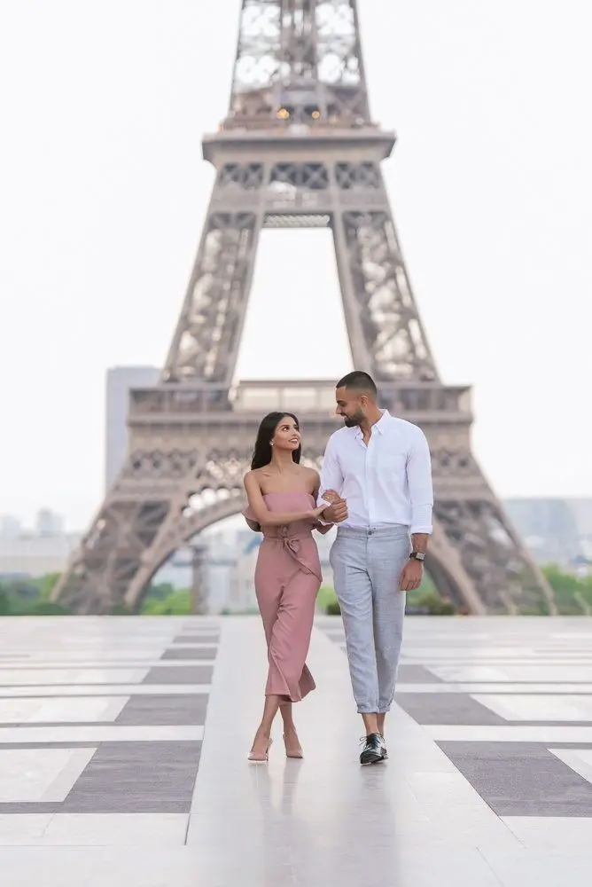 Download Couple Walking Near Eiffel Tower Wallpaper