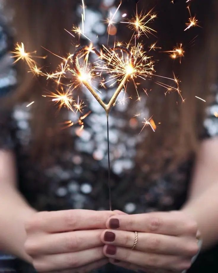 Download Sparkler Image in Girl's Hand with Burgundy Nail Polish