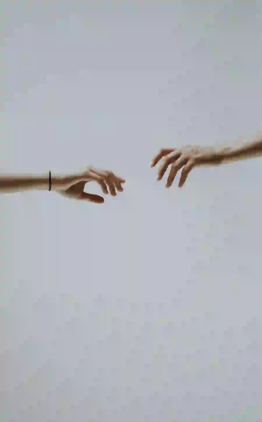 Background and profile of two hands reaching each other like the famous painting of the gods