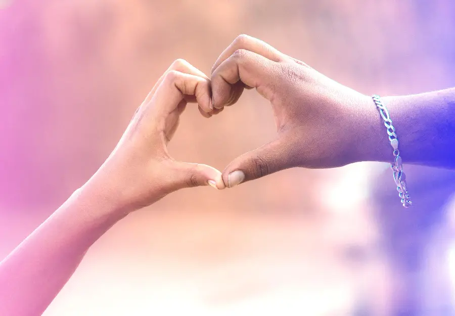 Background and background of a very romantic heart made with the hands of a couple 