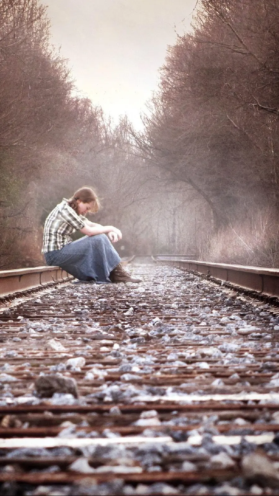 Sad picture of a girl on a train track suitable for a profile