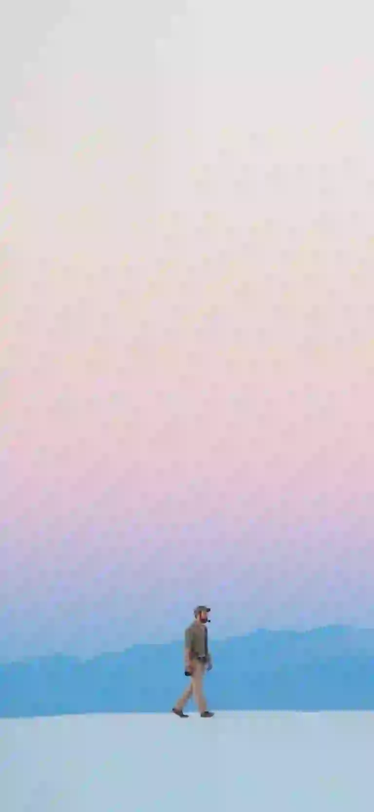A special picture of snow falling on the ground at sunset, suitable for a mobile background