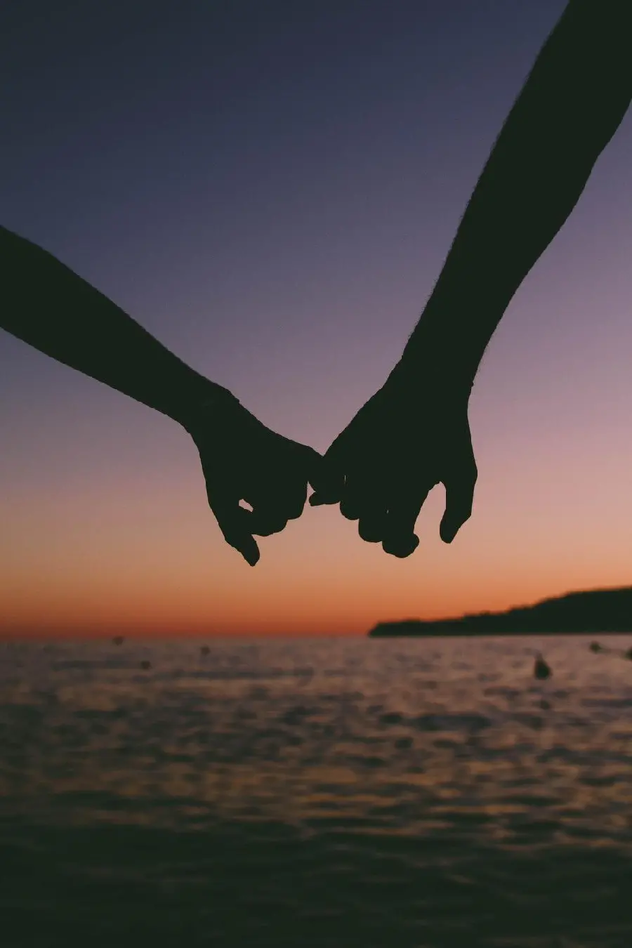 Wallpaper of hand in hand at sunset on a beautiful beach for relaxation