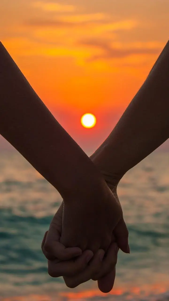 Beautiful couples walking at sunset on the beach, attractive wallpaper for dating