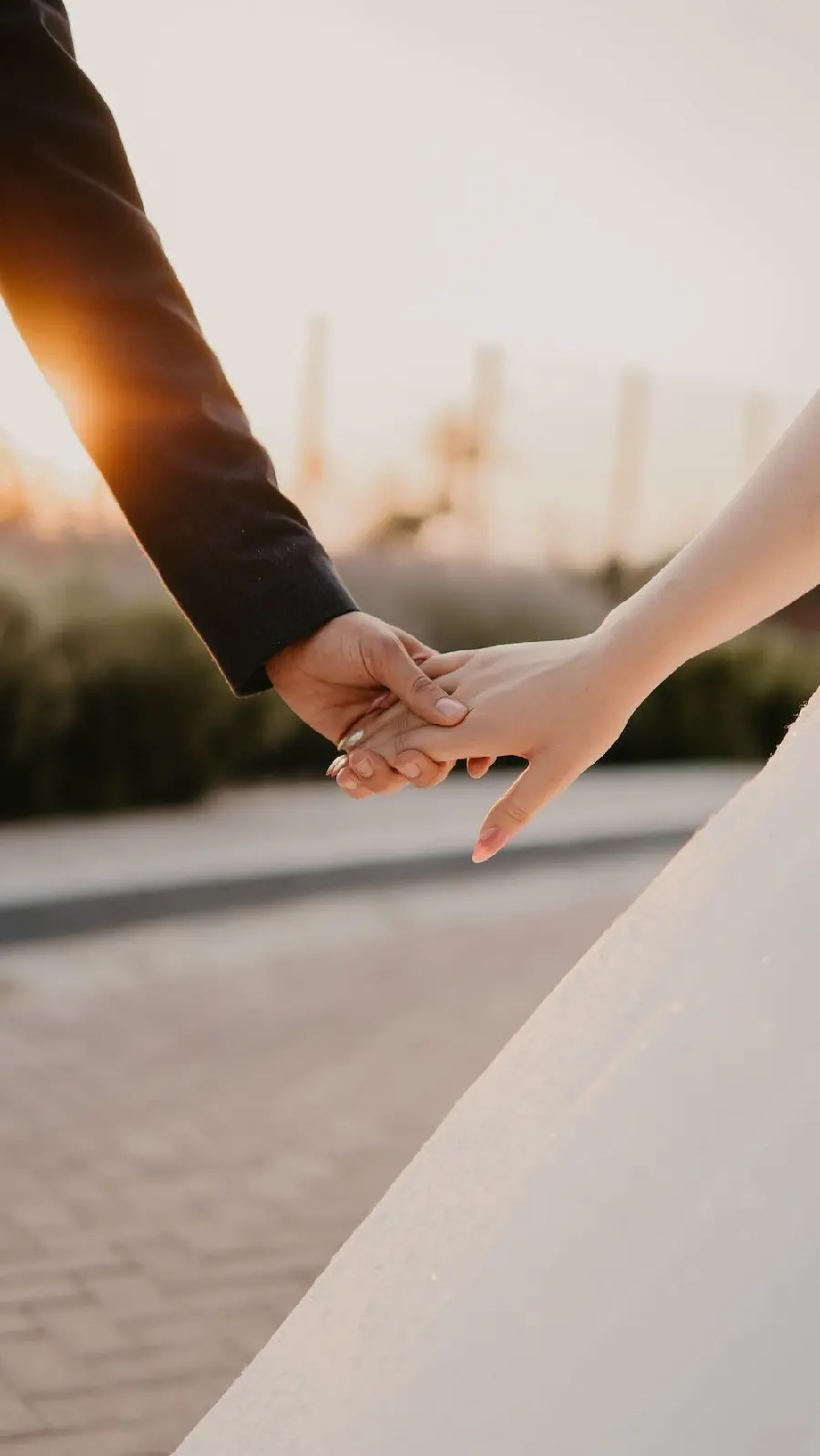 A beautiful picture of the hands of the bride and groom at a wedding for a profile