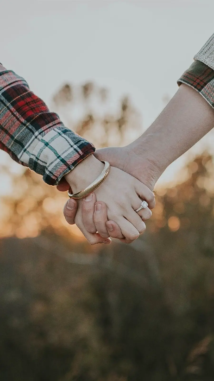 A picture of a beautiful couple holding hands in nature for a profile