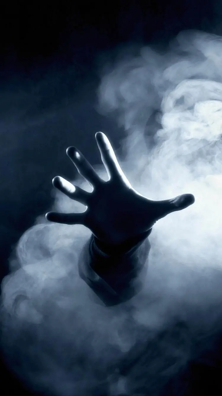 Mobile background and wallpaper of a hand asking for help in the dark