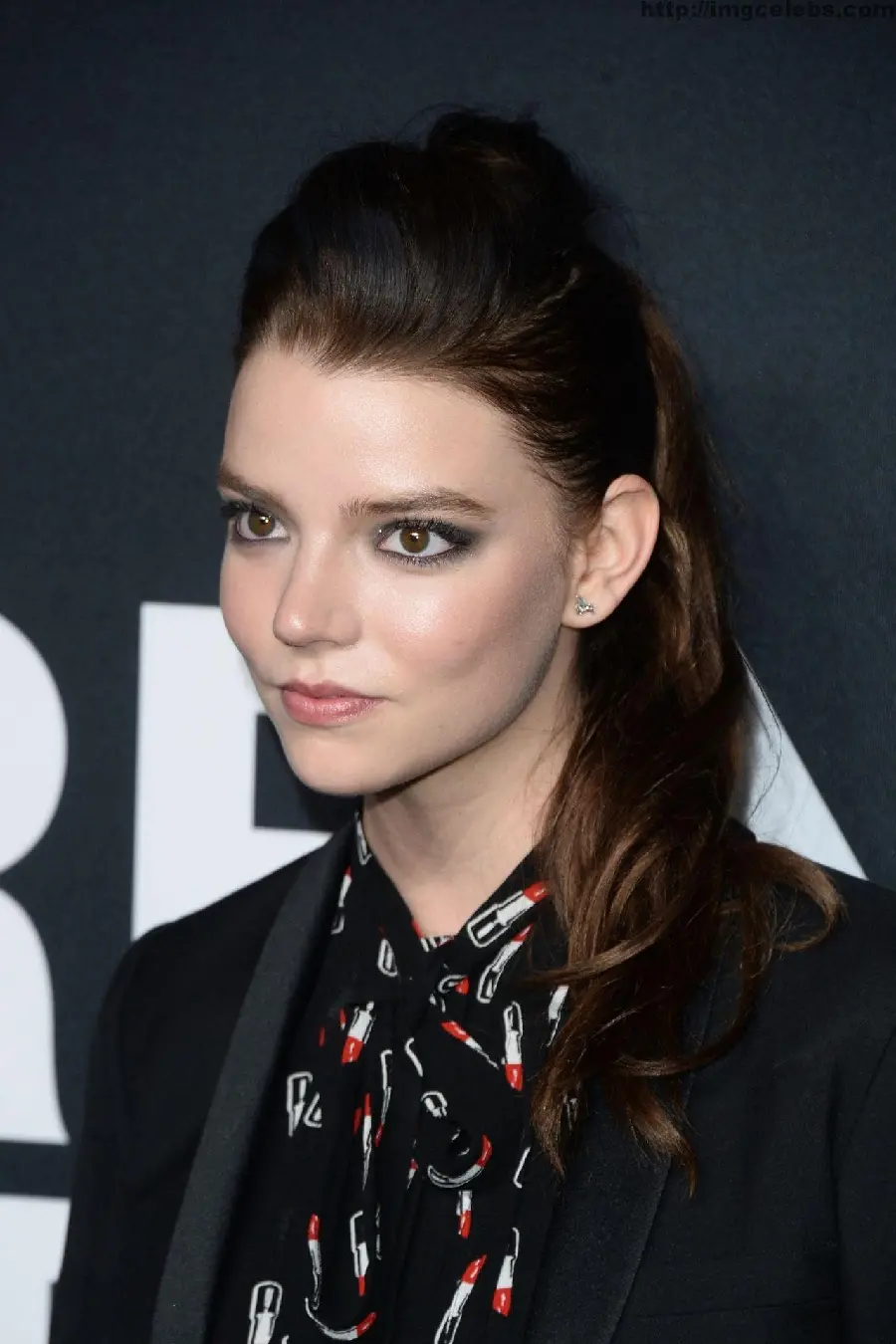 Anya Taylor Joy on the red carpet in a black dress and a serious face