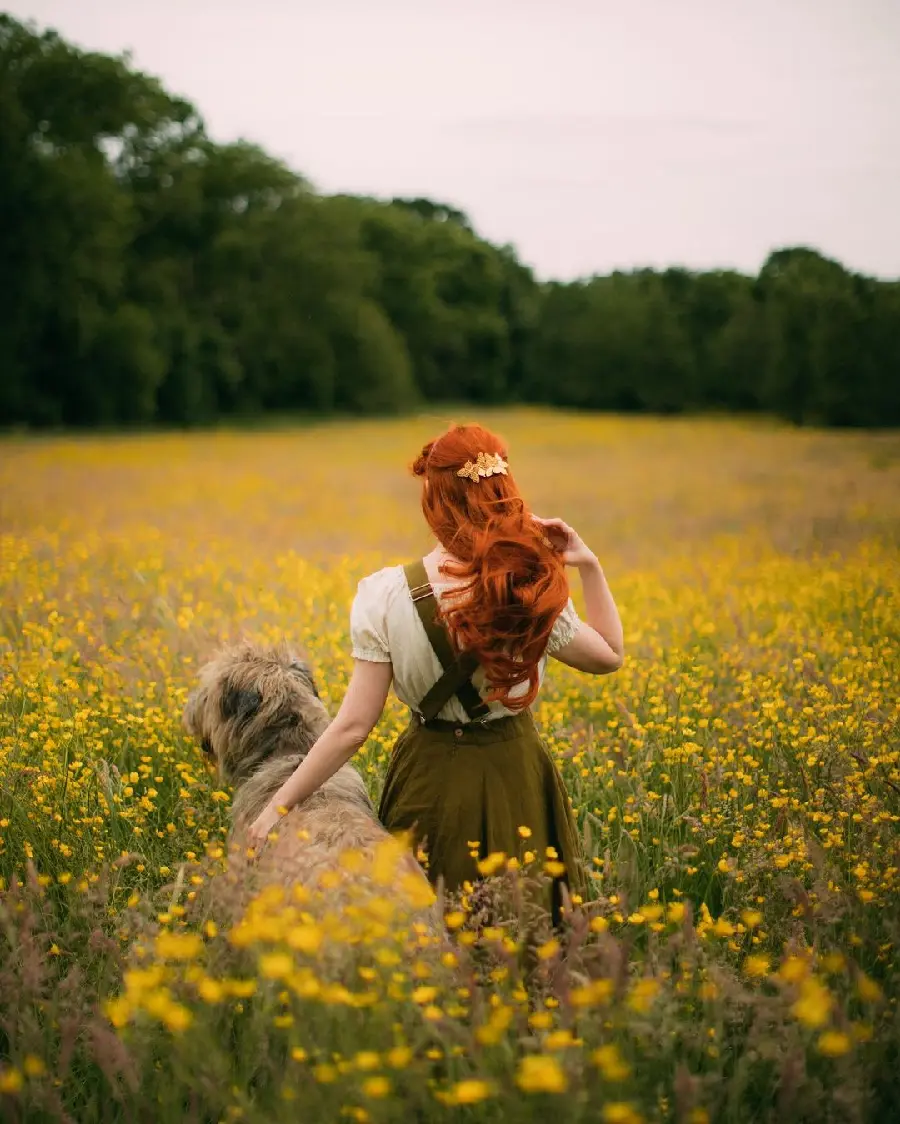 Redhead model with dog in flower field photography idea