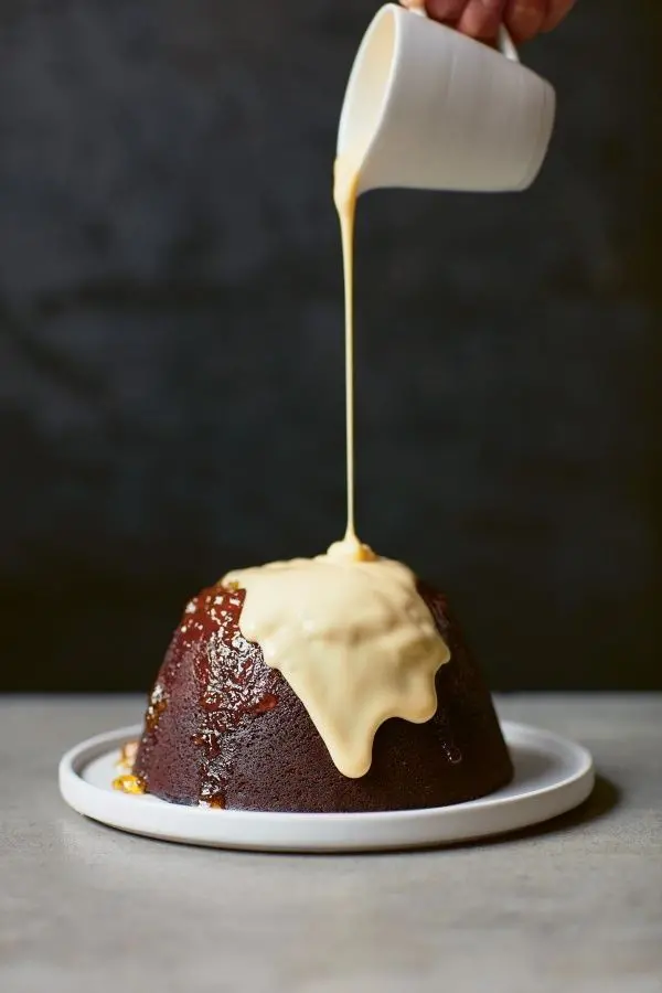 Chocolate plum pudding with white sauce photo for World Plum Pudding Day