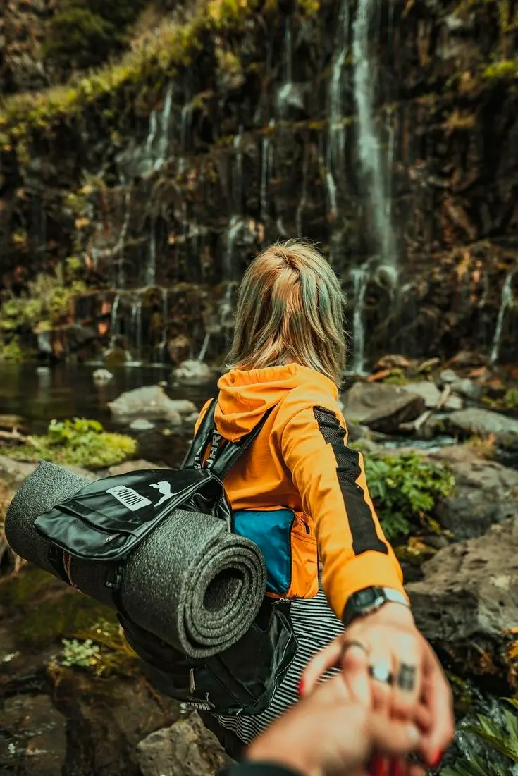 Girl tourist back view by beautiful waterfall profile picture