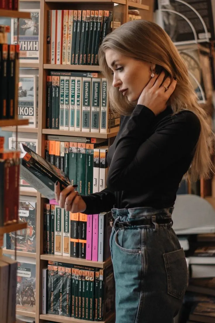 Beautiful girl reading book in library for profile picture