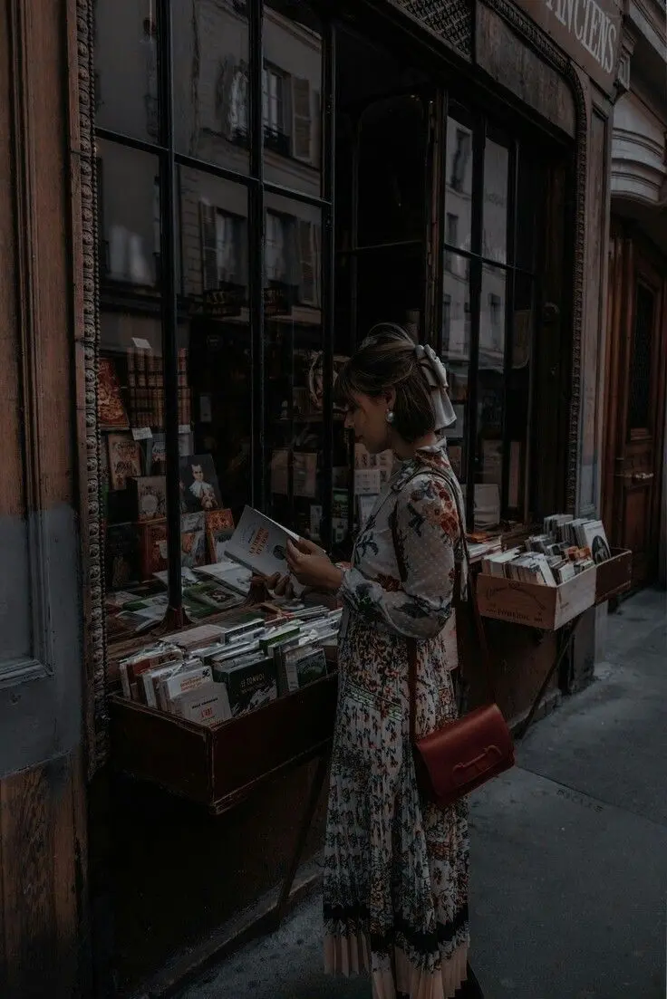 Interesting profile picture of beautiful girl reading book on street