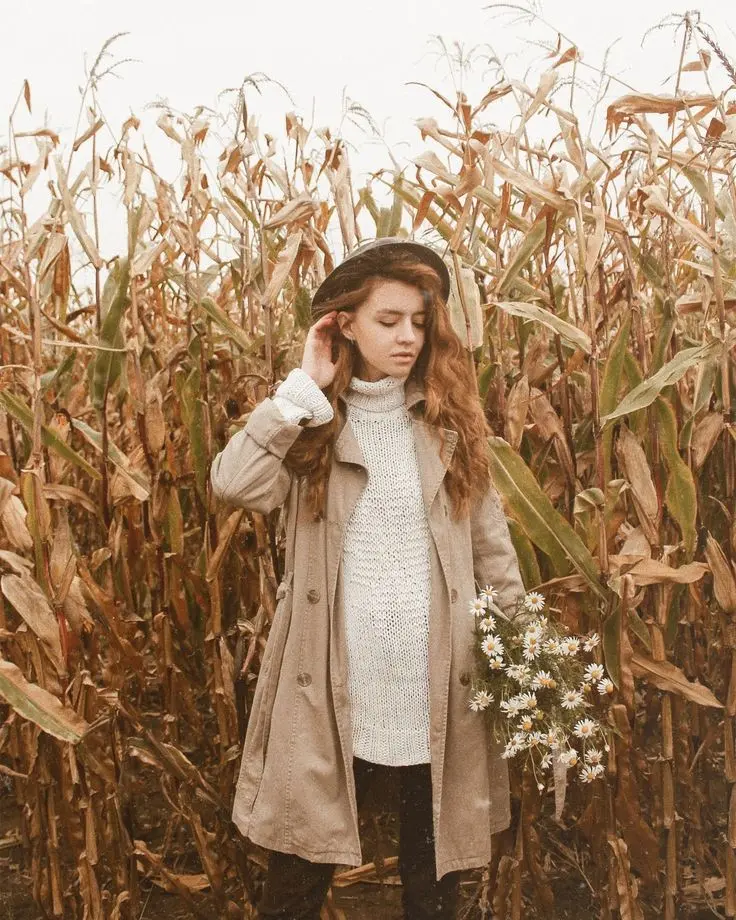 Premium quality photo of a girl standing among dried corn stalks