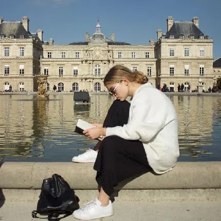Girl reading book by sea high quality profile picture
