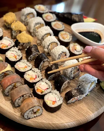 Photo of delicious colorful sushi with soy sauce accompaniment