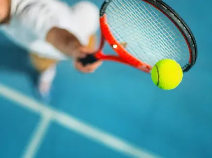 Tennis racket in athlete hand profile image for World Tennis Day