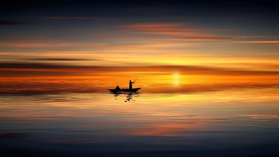 Interesting photo of a boat in the middle of the sea at sunset suitable for computer and laptop backgrounds