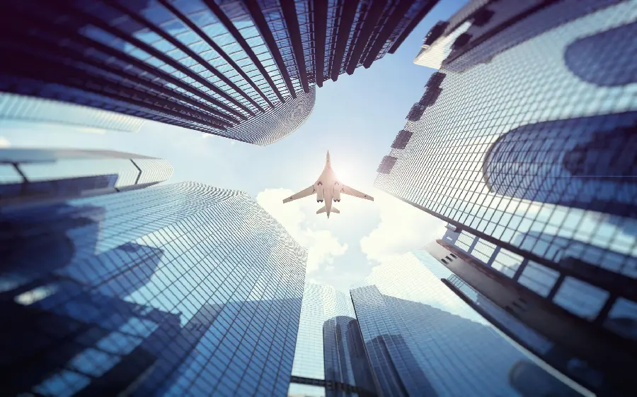 A graphic quality photo of a plane passing over tall buildings in HD quality for mobile backgrounds