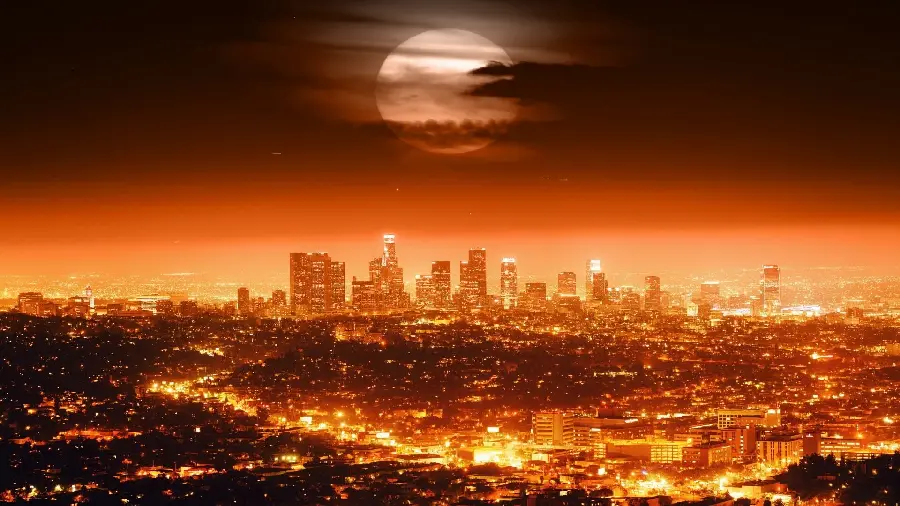 Photo of the city of Los Angeles with famous towers in downtown and a beautiful moon