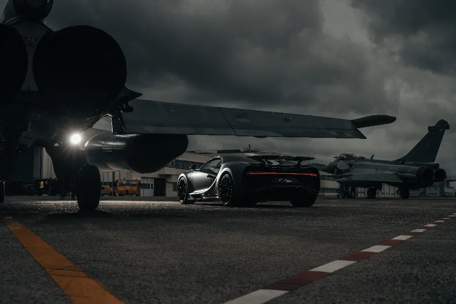 Photo of Bugatti Chiron next to a high-speed jet for car enthusiasts' profiles