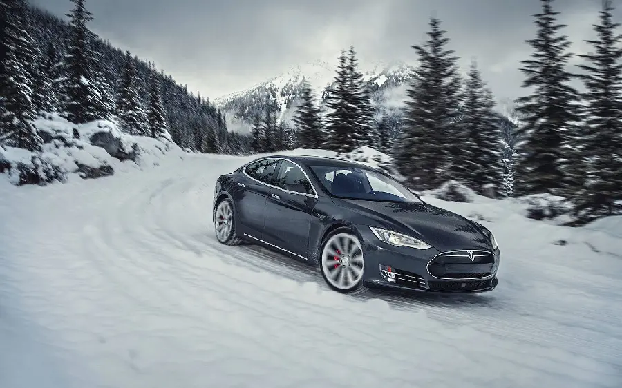 Photo of a stylish and attractive Tesla in the snow