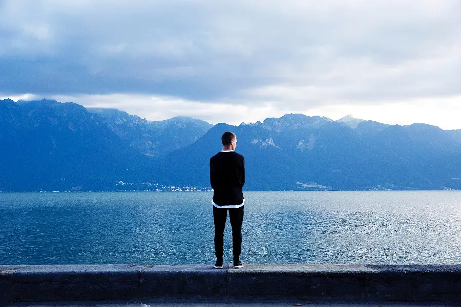 Background of a thoughtful and focused man by the sea and looking towards the horizon