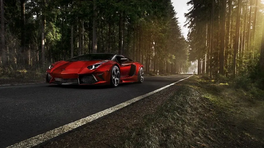 Photo of a red Lamborghini Aventador in an autumn and forest nature landscape
