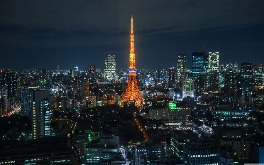 A photo of a Tokyo light tower in the center of the city with a design similar to the Eiffel Tower