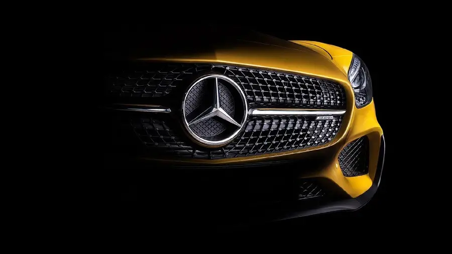 The half-hidden face of the golden Mercedes-Benz and very attractive