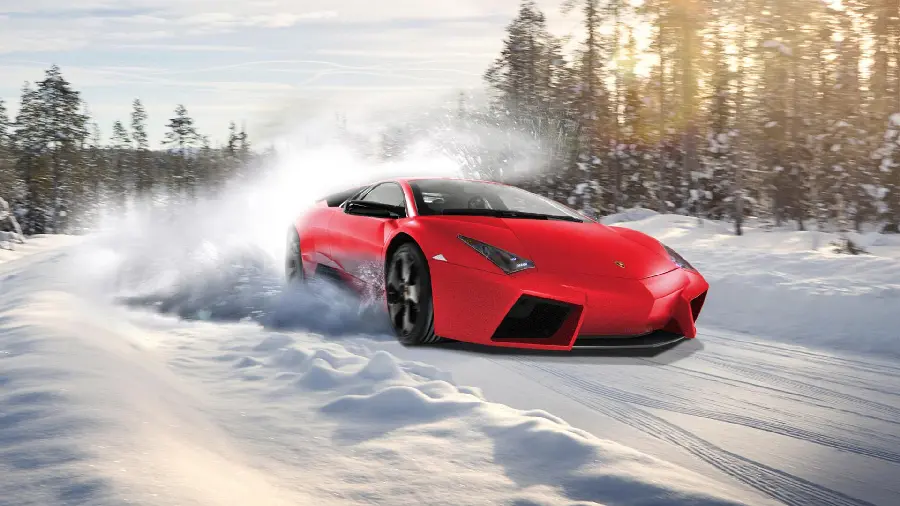 Photo of a red Lamborghini on a snowy and icy road for wallpaper