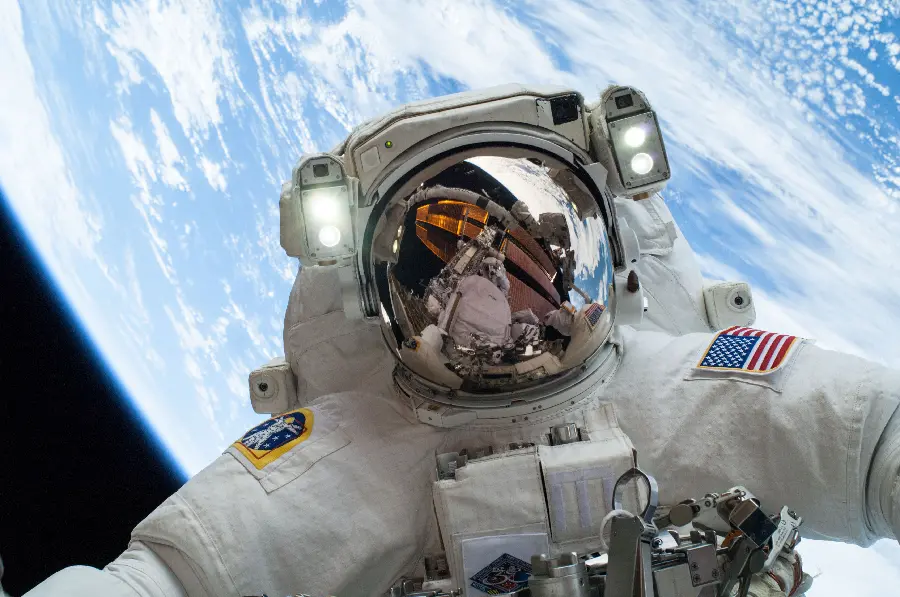 Photo of NASA astronaut in space and hovering above the Earth
