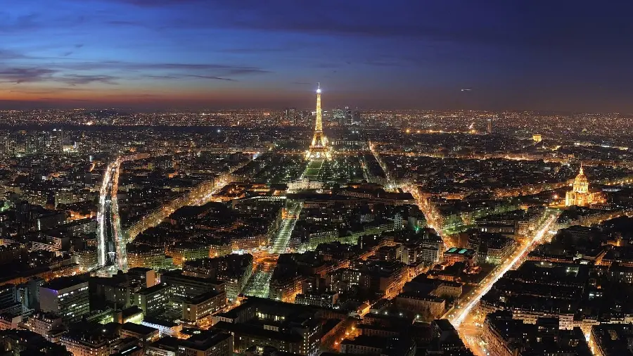 Beautiful photo of the city of Paris from above with illuminated streets for computer background