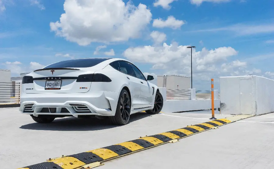 Photo of the rear view of a white and special Tesla
