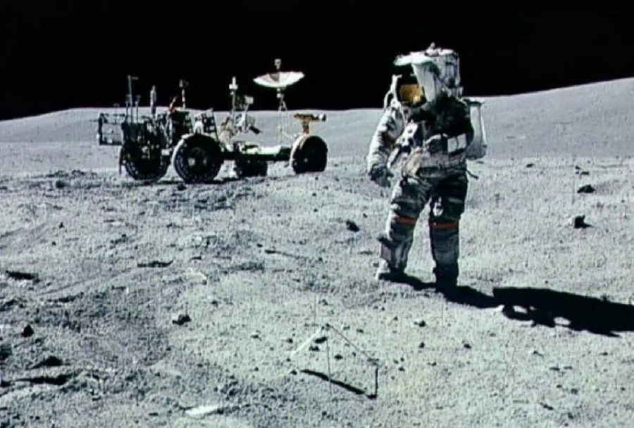 Old black and white photo of NASA astronaut and the moon with Apollo 15