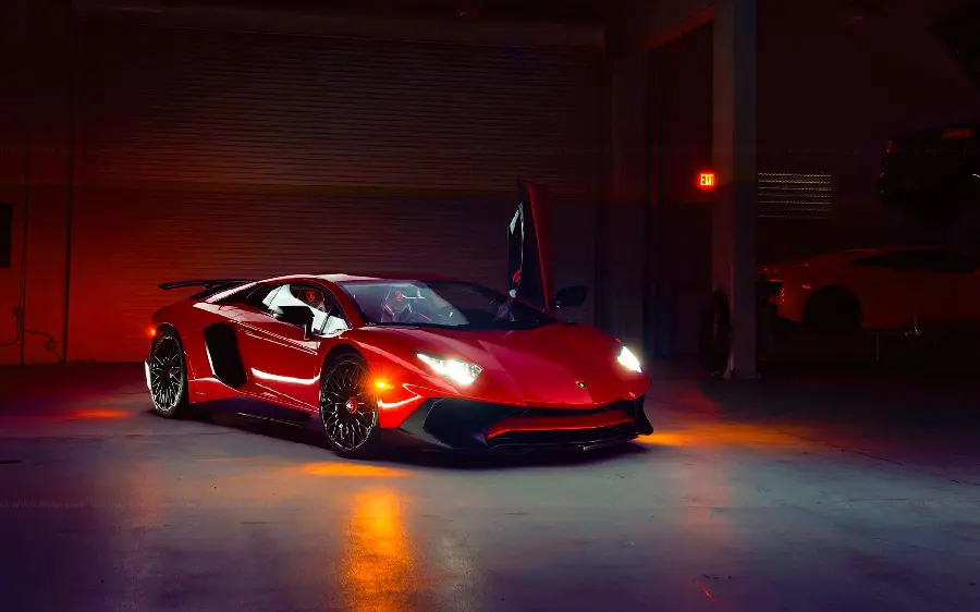 Photo of cherry red Lamborghini car with bright lights and sports