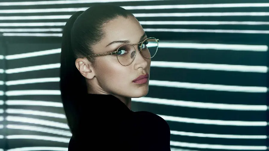Bella Hadid photo with glasses and ponytail and black dress