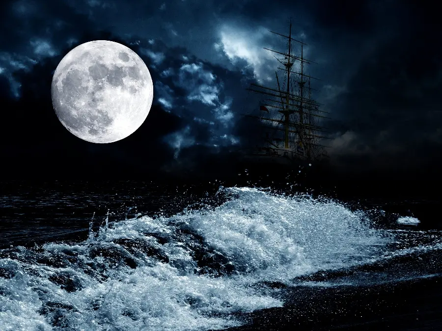 High quality photo of ocean waves roaring on a cloudy night with a big moon in the sky