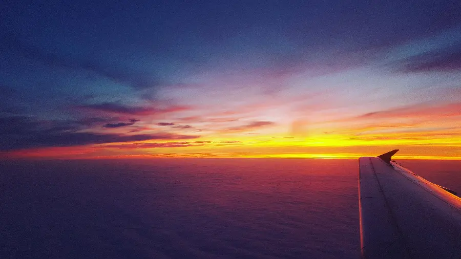 A pleasant picture of the sunset sky from the view of the plane's wing for your profile