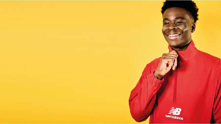 Bukayo Saka wallpaper in Arsenal with yellow background for Windows 11