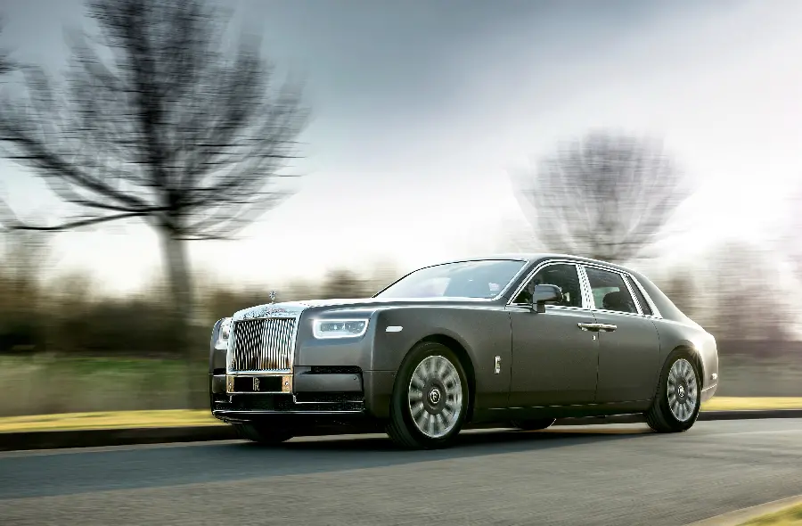 Rolls Royce car photo on the asphalt road and forest background