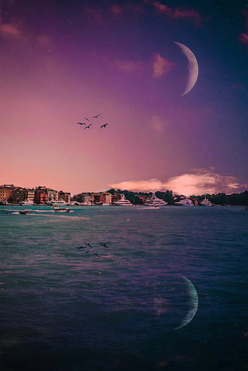 Moon background with pink clouds in clean blue sky