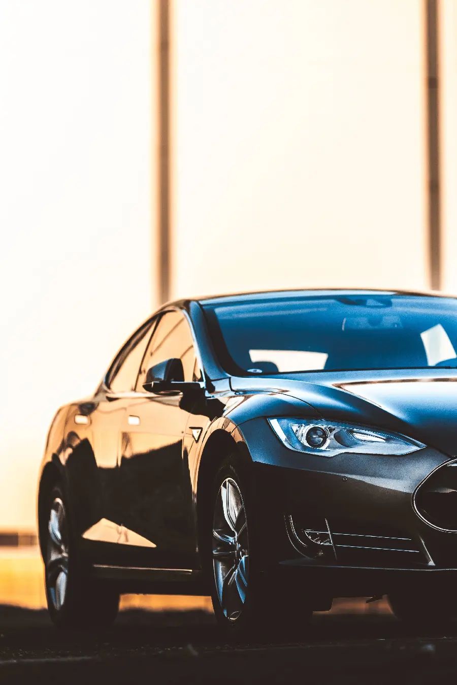Background image of the headlights and the beautiful face of the Tesla