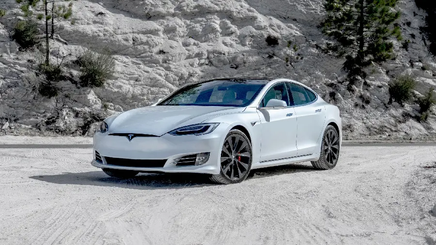 Photo of a white Tesla five-seater sedan