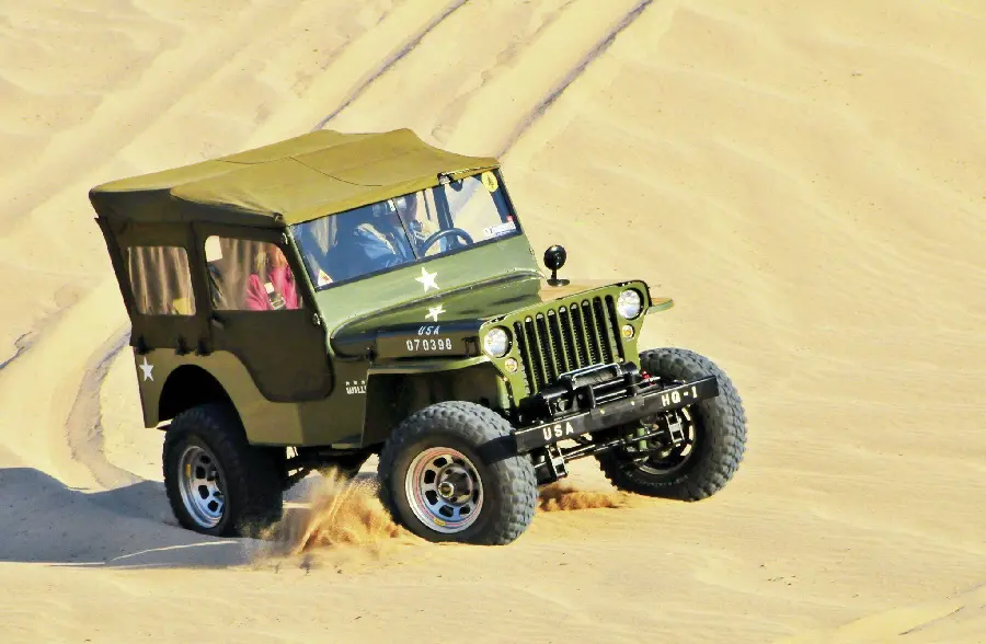 Interesting picture of fast moving olive jeep in the desert with high quality